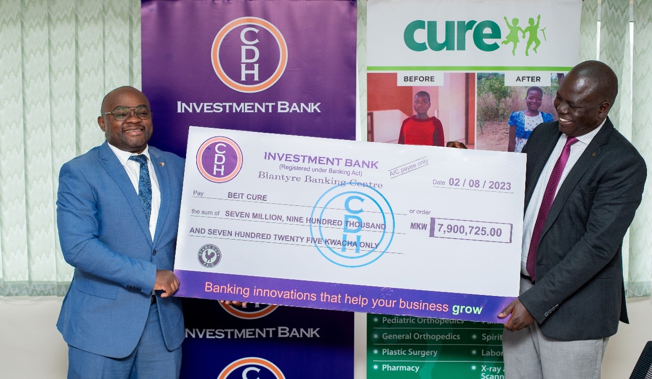 Mr Zondwayo Mafuleka, Chief Treasury Officer CDH Investment Bank hands over funds to Mr Elly Chemey, Executive Director, Beit Cure International Hospital