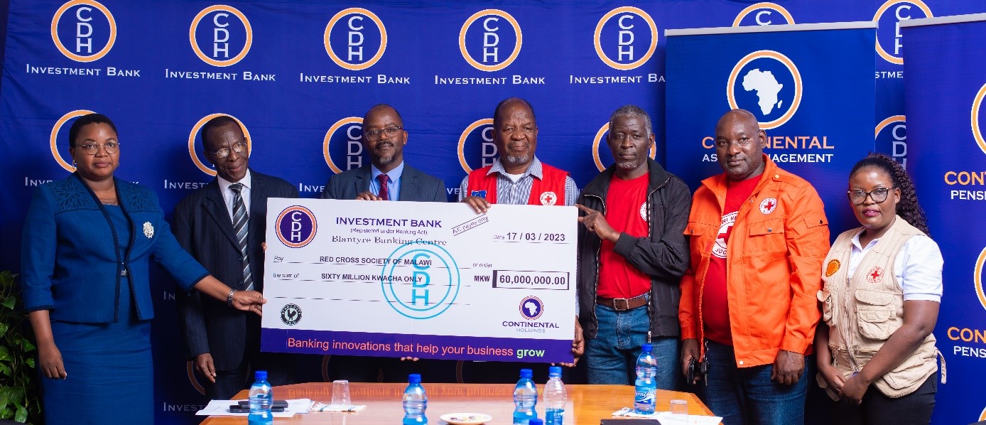 Representatives from Continental Holdings Limited and CDH Investment Bank hand over funds to representatives from the Malawi Red Cross Society