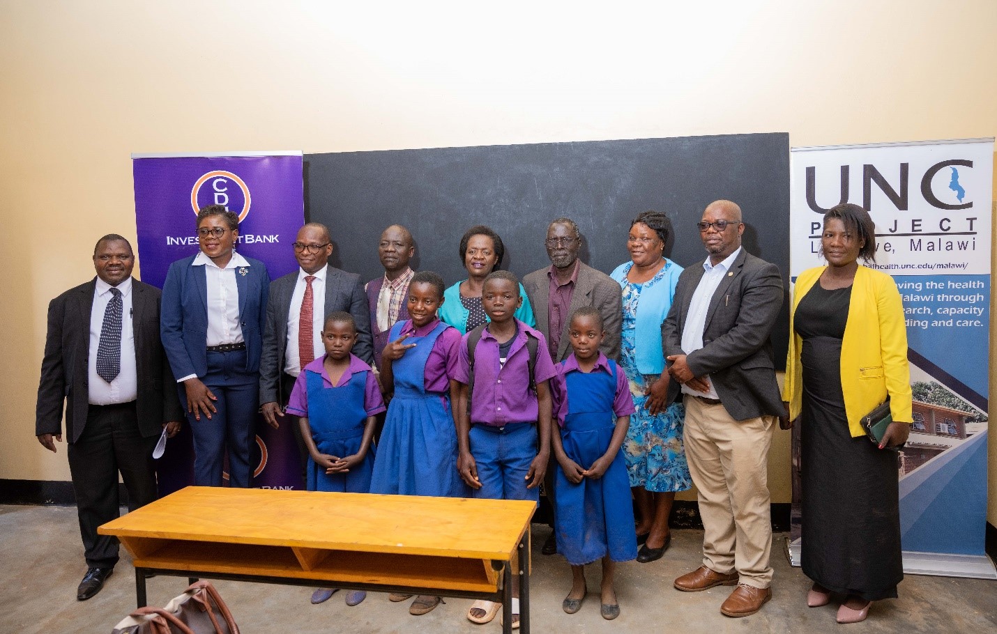 Representatives from Dzama community, UNC Project Malawi, CDH Investment Bank pose with the Guest of Honor Mrs Judith Chiwoko (5th left) inside the school block. Representatives from Dzama community, UNC Project Malawi, CDH Investment Bank pose with the Guest of Honor Mrs Judith Chiwoko (5th left) inside the school block.